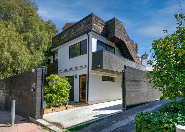  Tandem carport fits 2 vehicles or equipment truck/van. Features two secure sliding gates for easy load-in/out. Ideal for production parking. 
