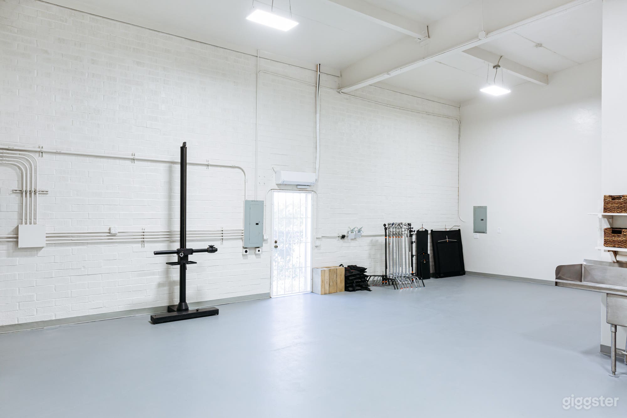 MAIN STUDIO: This area is 33’ x 16’, has 16’ ceilings, and can provide a dark setting if you want to escape the daylight and make your own light. There is enough room for TWO 9’ seamless background setups. Our 9’ Bogen Salon studio stand is yours to use. 