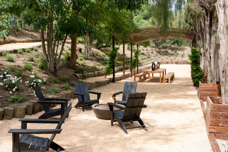  An outdoor communal area with designer Adirondack chairs and fire pits.  