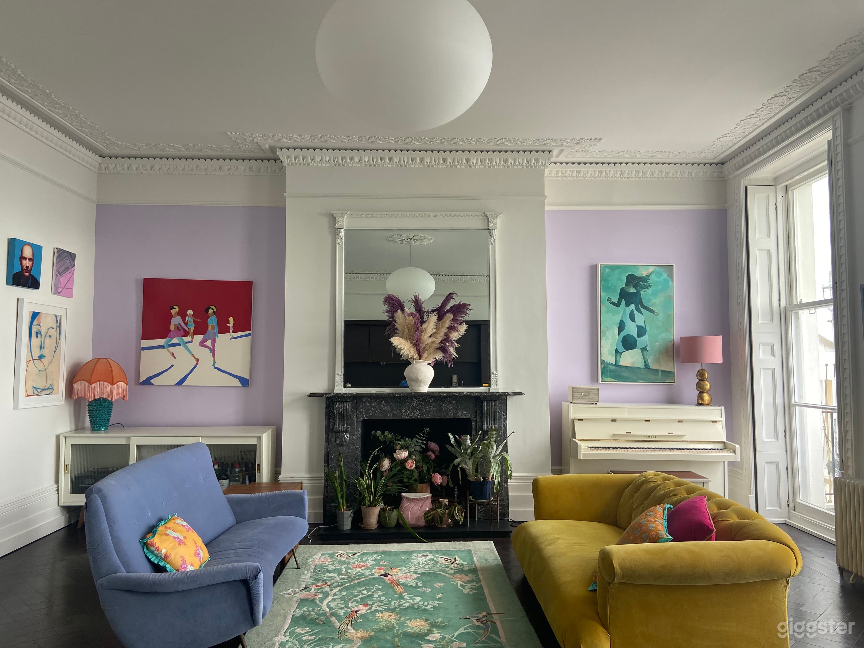 Eclectic mix of midcentury furniture and colourful artwork by owner and friends