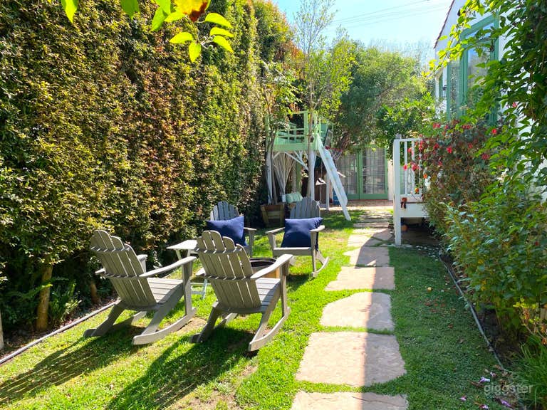  Enchanting Spanish-Style Home with Lush Greenery and Treehouse 
