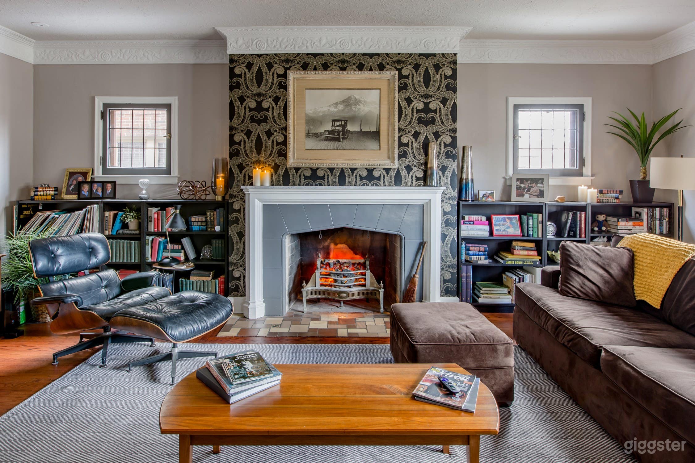 A large family room with working fireplace and library