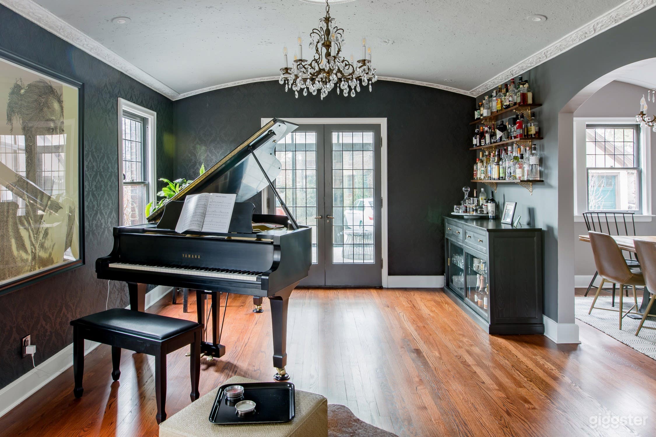 Formal dining room now turned into music room and bar lounge. Grand Yamaha piano, large dry bar with selection of glassware and bottles, vintage 1950s Motorola record console and more.