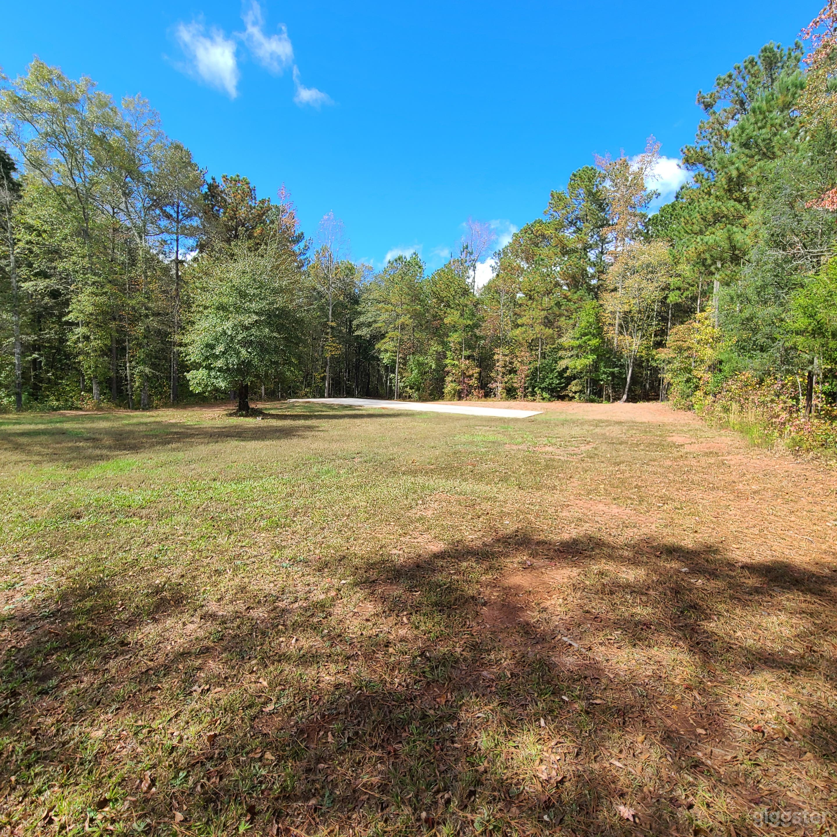 Expansive Bluff Backyard with Woods and Concrete Slab Photo 1