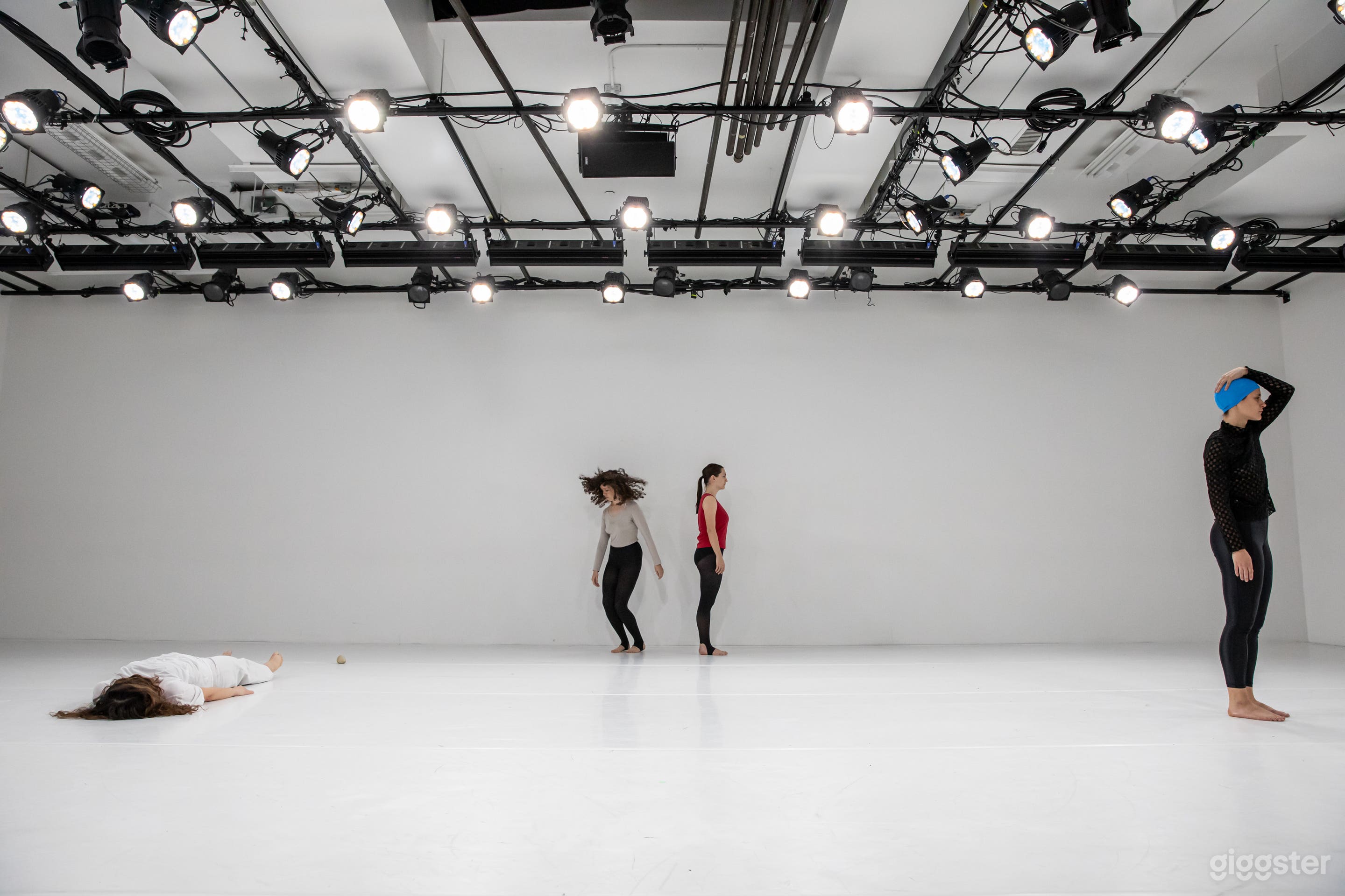 A dance performance in the Large Studio/Theater with theatrical lighting overhead.