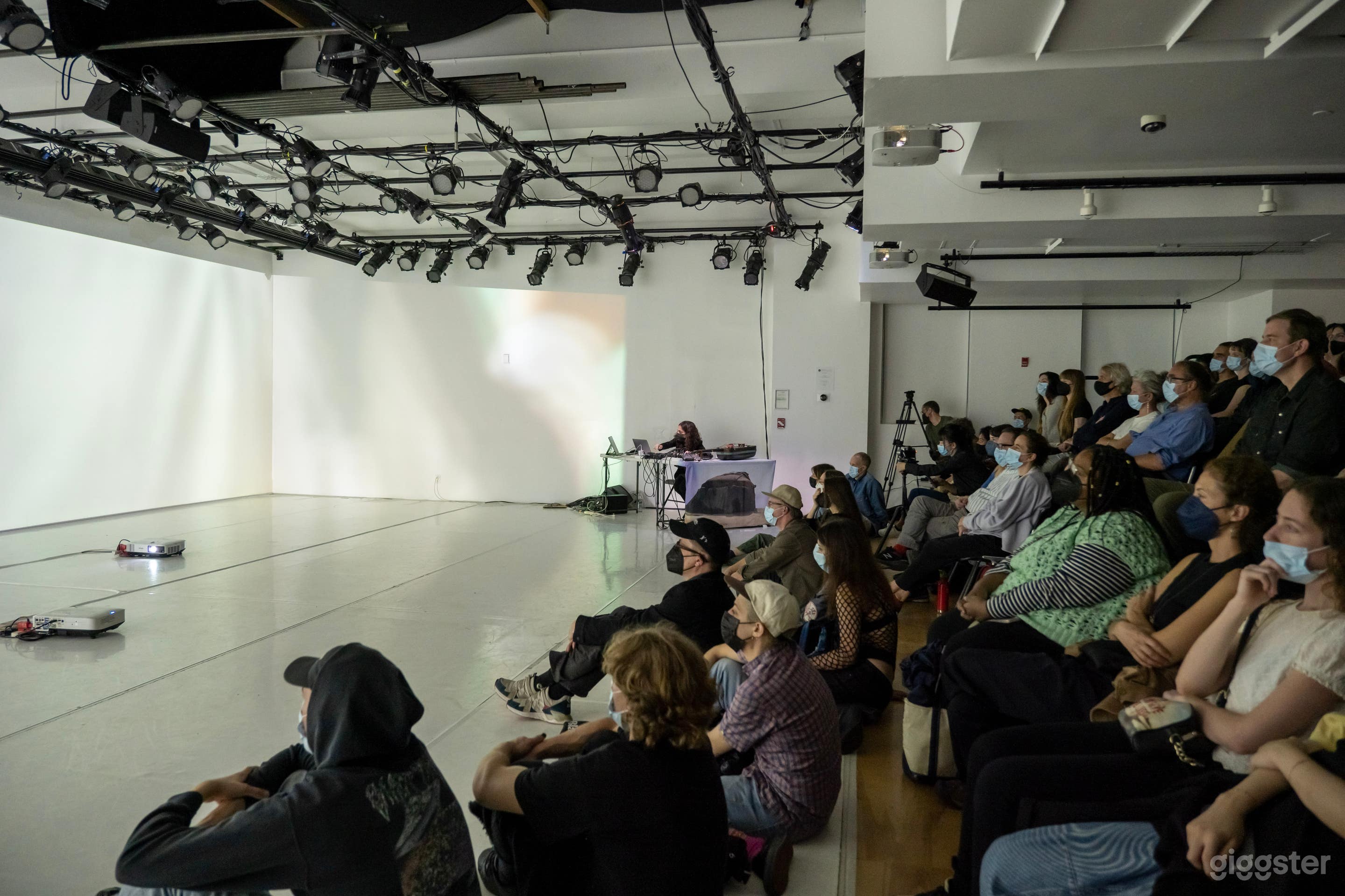 View of the stage and audience risers in the Large Studio/Theater.