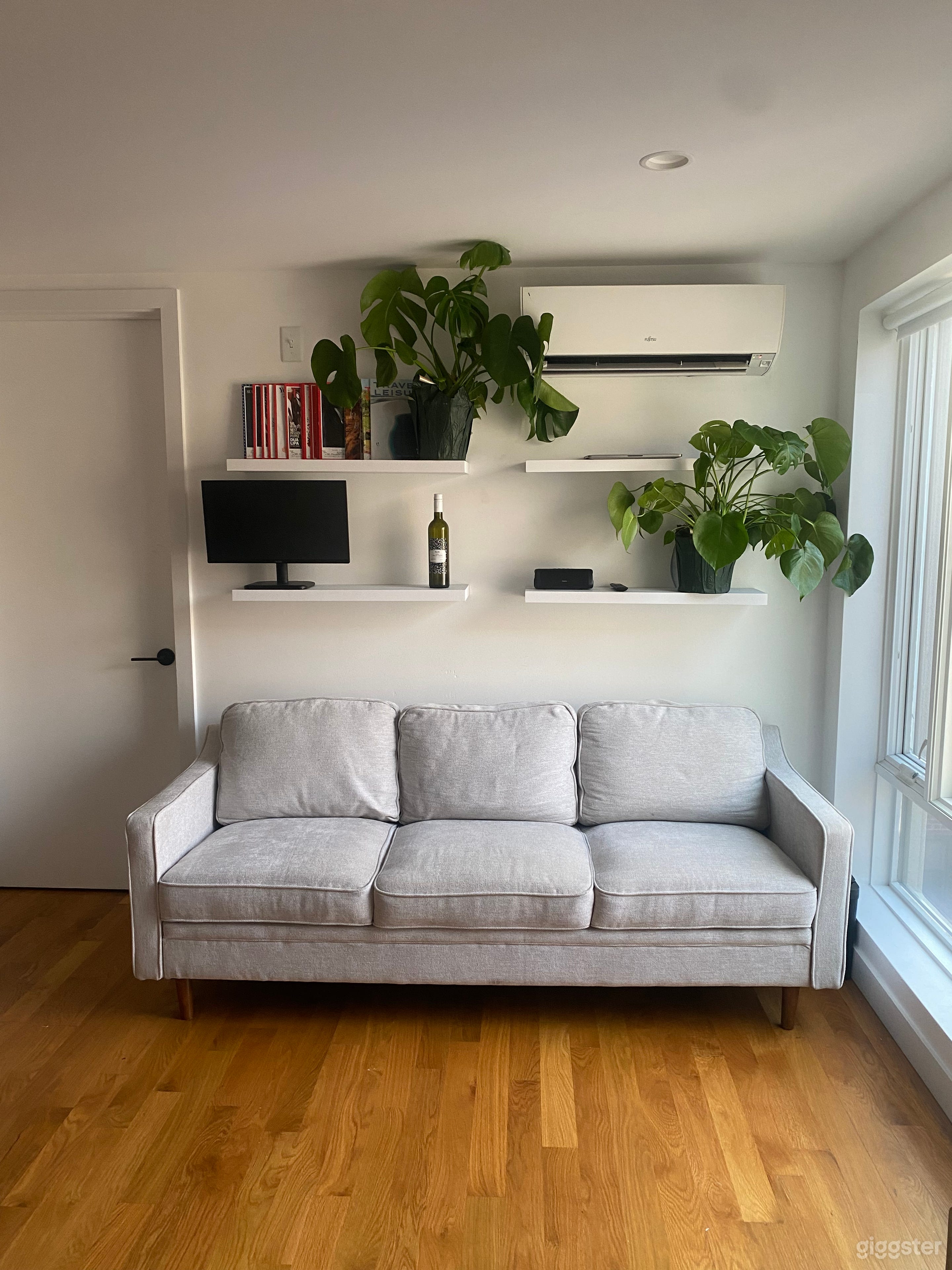 A minimally furnished living room, with the option to rearrange the furniture as needed.
