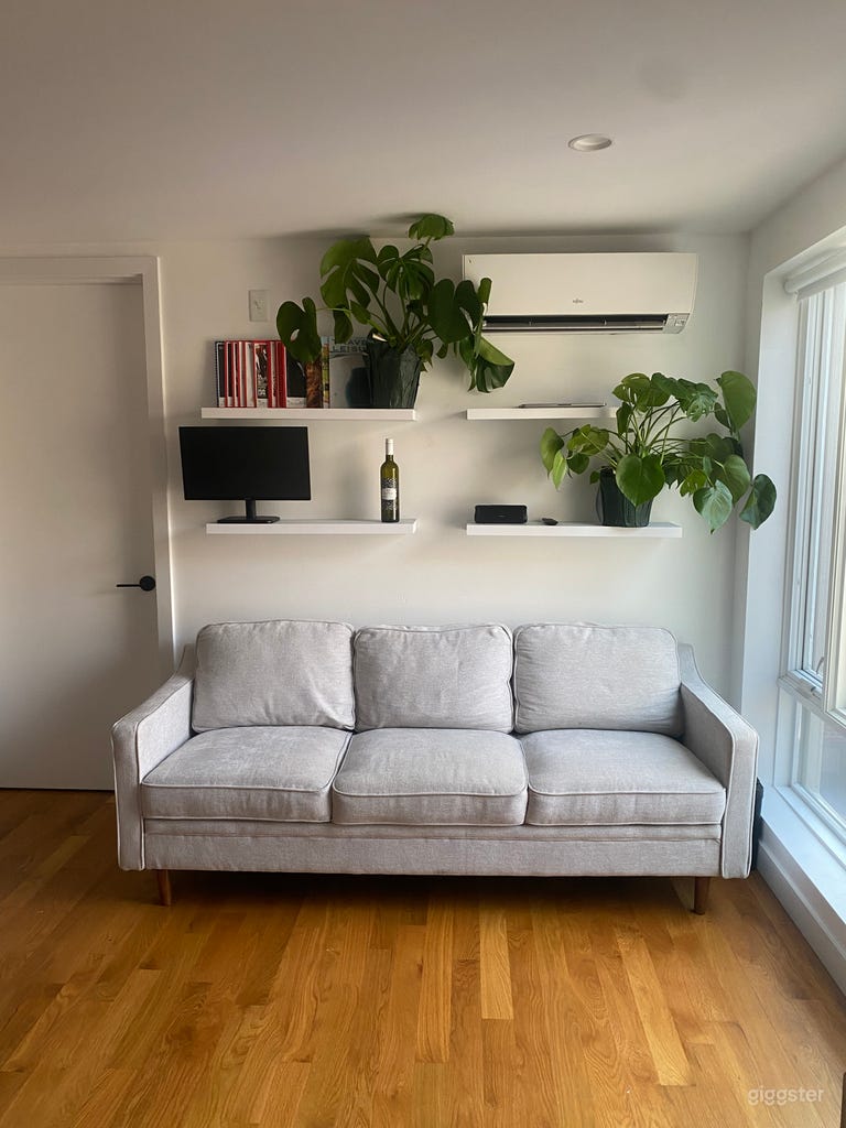  A minimally furnished living room, with the option to rearrange the furniture as needed. 