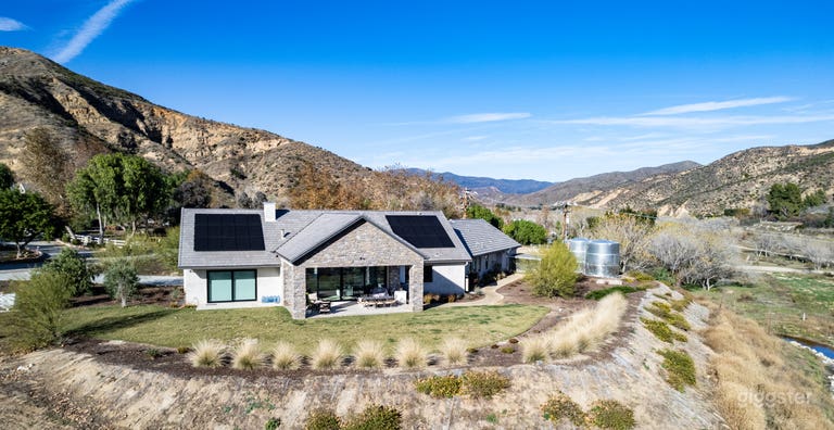  Back of house with ranch in background 