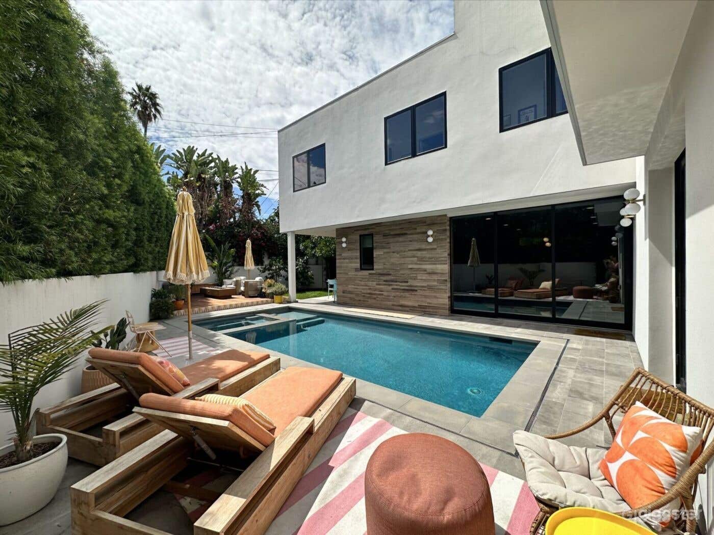 Palm Springs decor with pool, hot tub, lounging and dining areas.