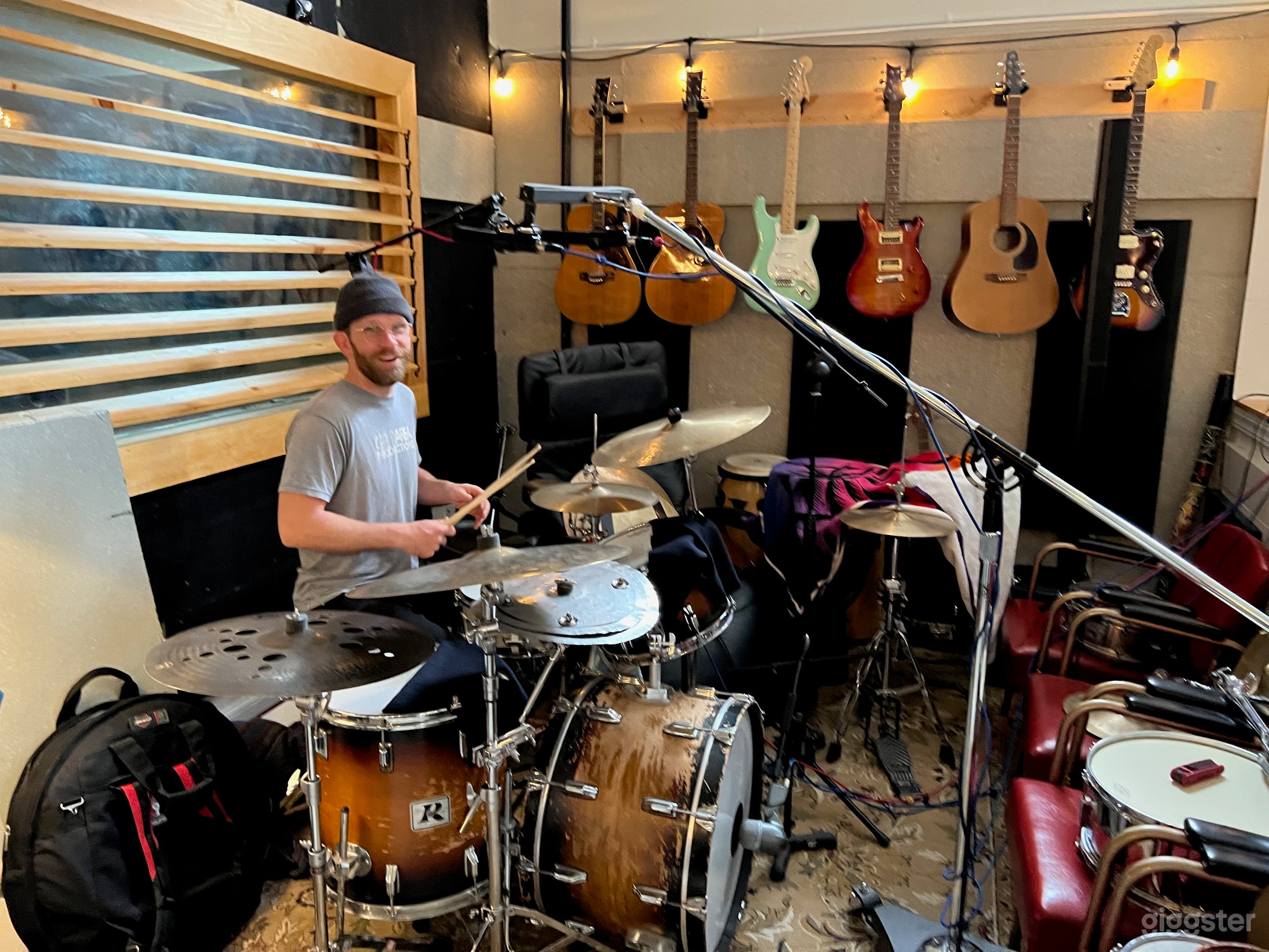 Drum area. Recording booth/isolation room behind those wooden louvers/glass.