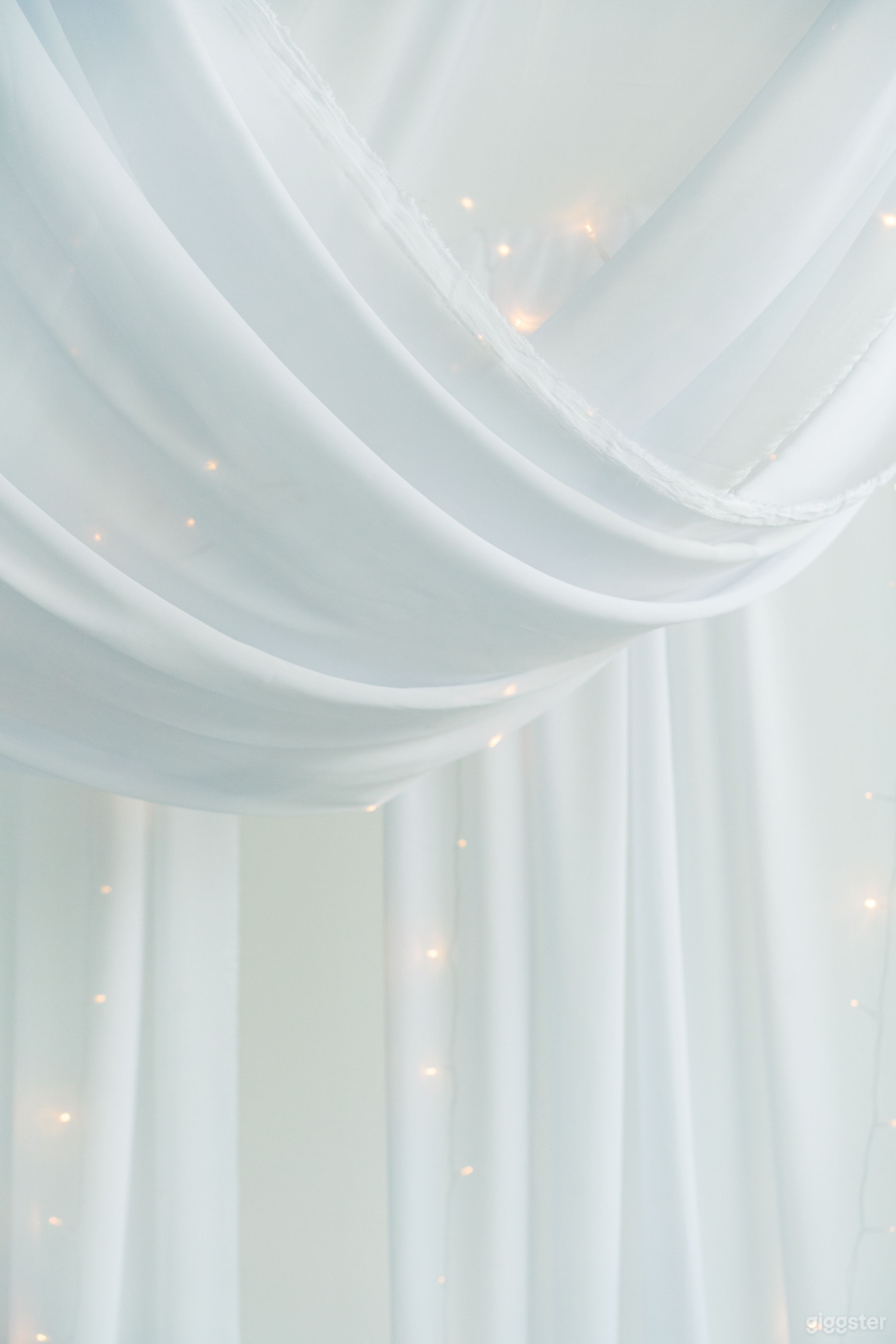 Part of our cottage bed holiday styled set -- draped chiffon with twinkling lights hang over the bed.