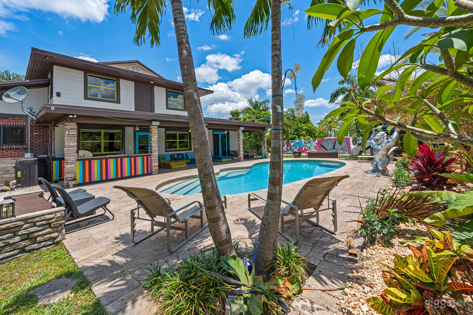 Palm-framed pool, sunny paradise.