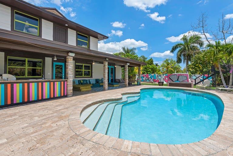  Sunlit pool with vibrant accents. 