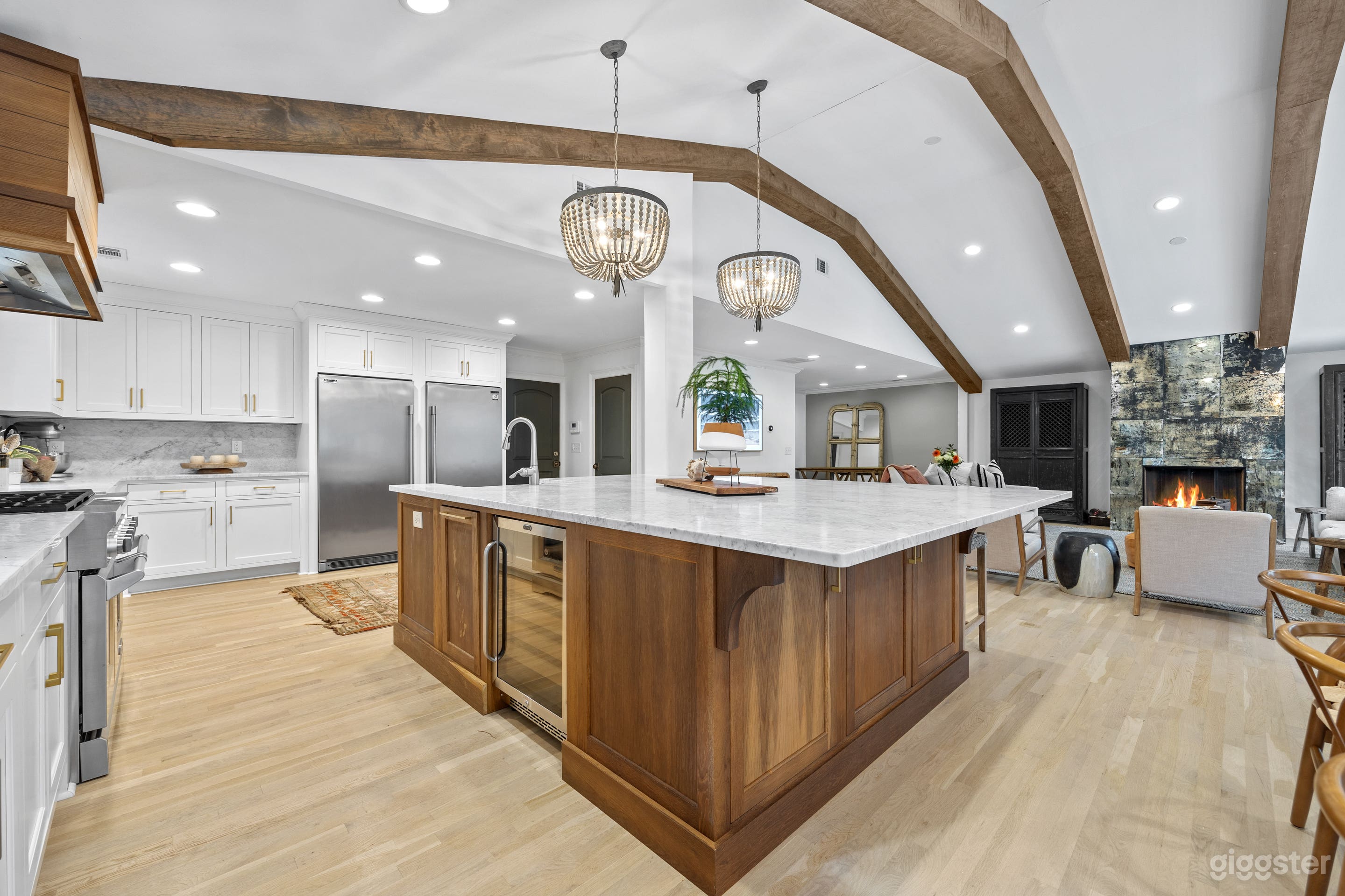 Antiqued mirror fireplace sets the stage for this amazing living space! Large chefs kitchen with exposed beams. 