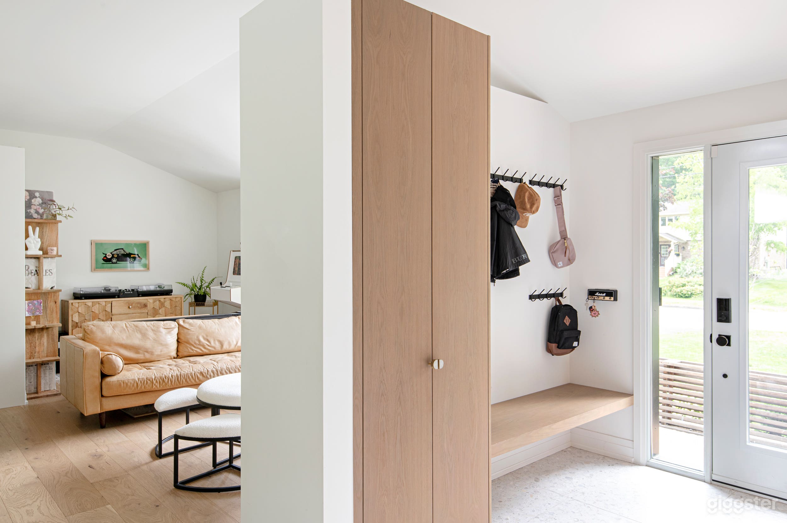 open space family room, lots of light, record/vinyl wall, dj setup, custom made arcade on wall. Lots of plants.