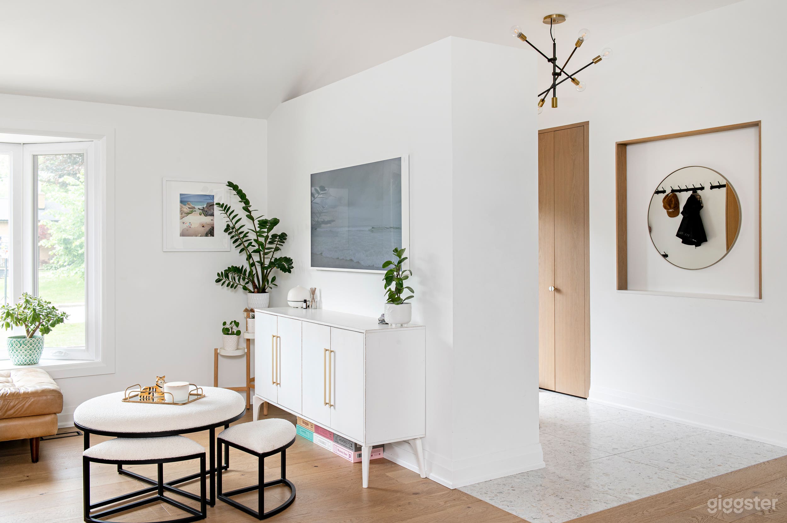 open space family room, lots of light, record/vinyl wall, dj setup, custom made arcade on wall. Lots of plants.