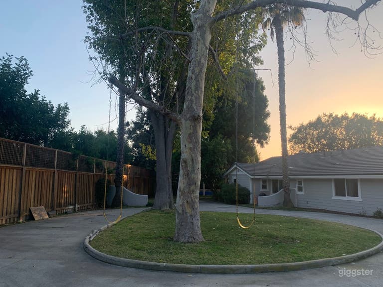  Circular driveway, trees with swings. 
 
