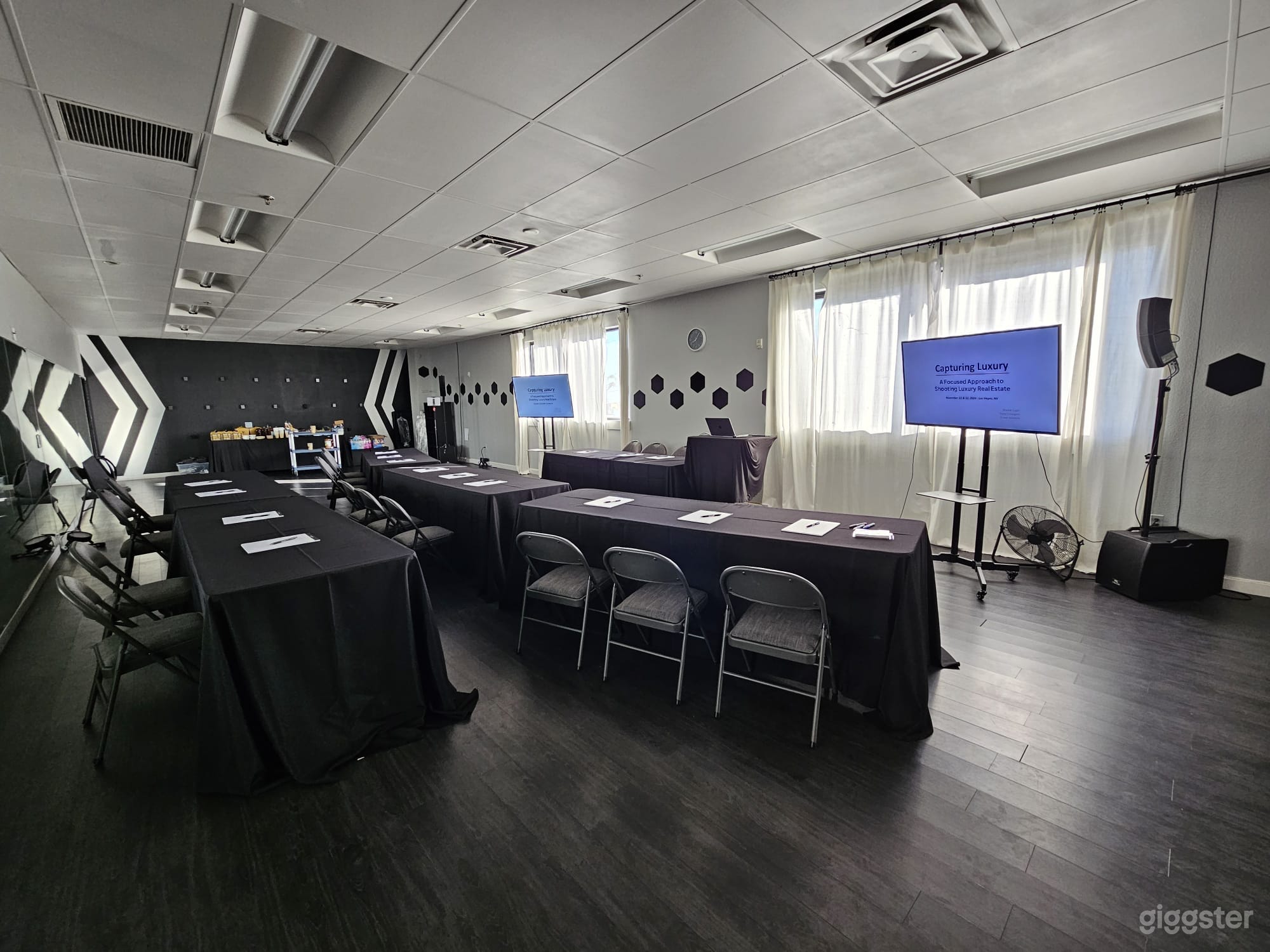 Sample set-up from a photography workshop held in Luna room. All visible furniture (tables, tablecloths, chairs, tv’s, and tv stands) optional add-ons for rentals.