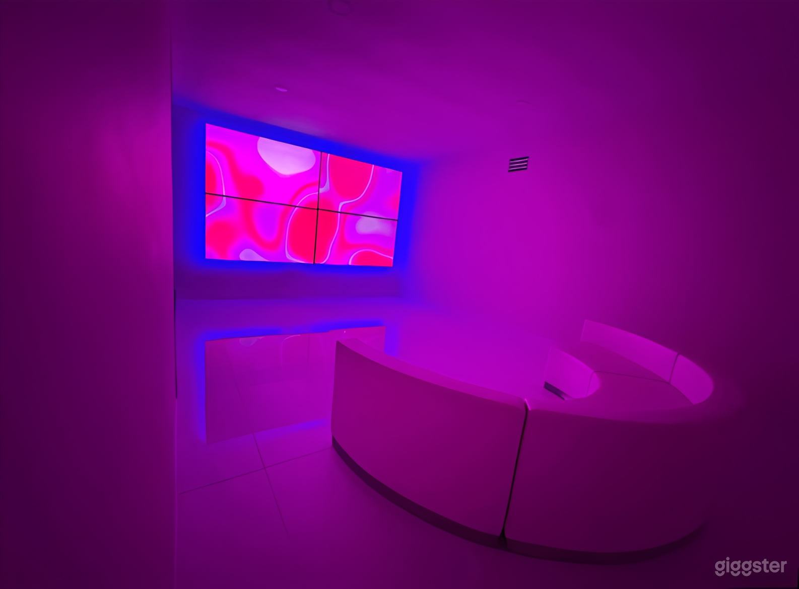 Modern White Event Space with LED TV Wall Photo 3