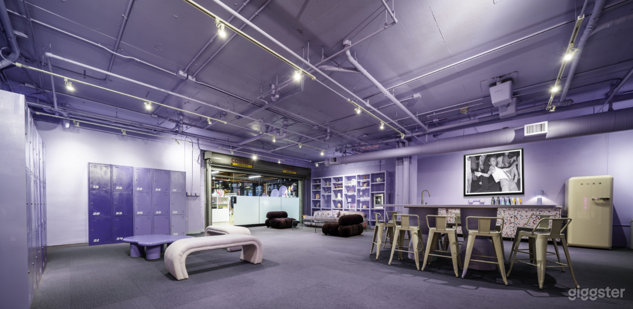 Color-flooded lounge with lockers.