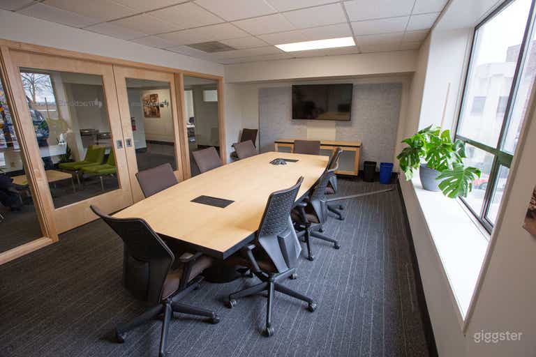 Our ‘Board Room’ caliber conference room suitable for formal meetings. Its large picture windows fill the space with light but the glass ‘barn doors’ give it an air of sophistication.  This is located on the second floor and is ADA accessible! 