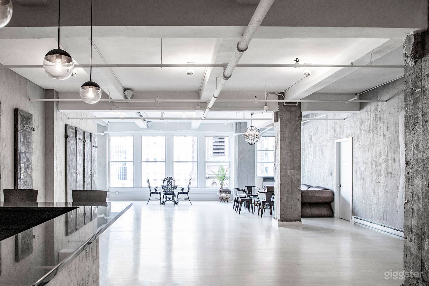 LOFT 29
- Wall of windows that pour in natural daylight
- White stained wood floors
- Exposed concrete walls and columns
- 100+ year old vintage metal doors