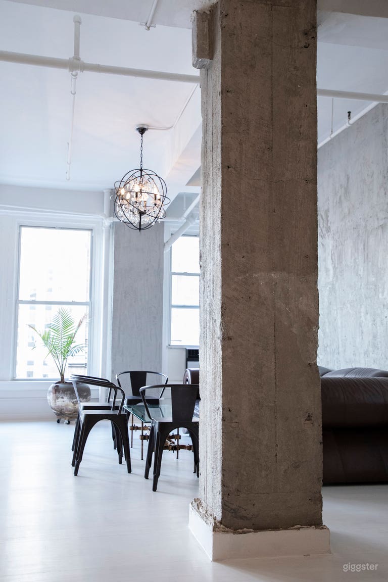  - White stained wood floors
- Exposed concrete walls and columns
 