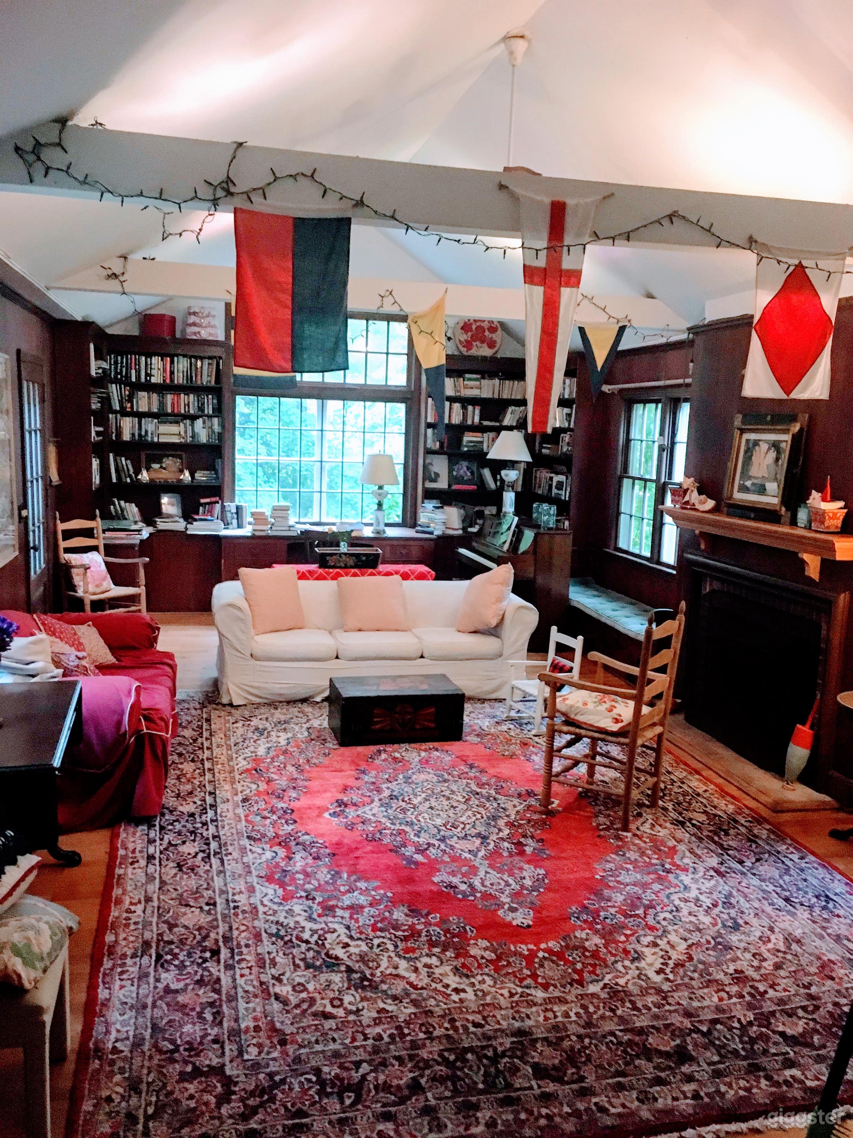 High ceilinged, beamed Library room with: bookcases, window seat, fireplace and multiple entryways. BIG= 630 sq. ft. 