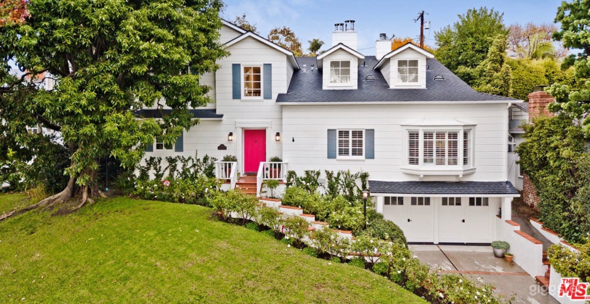 Charming facade on rolling green hill.