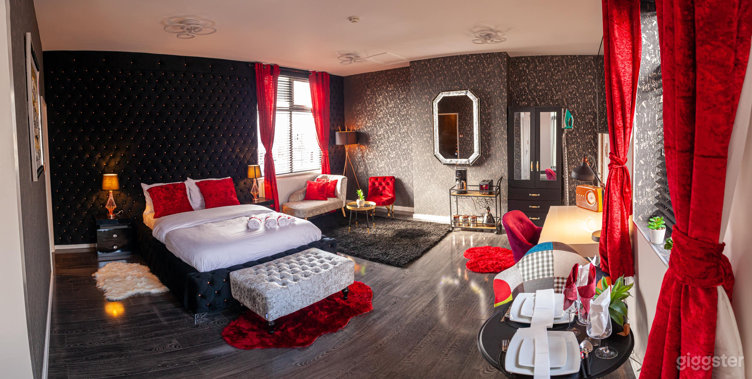 Luxurious penthouse suite with red , black and silver features 