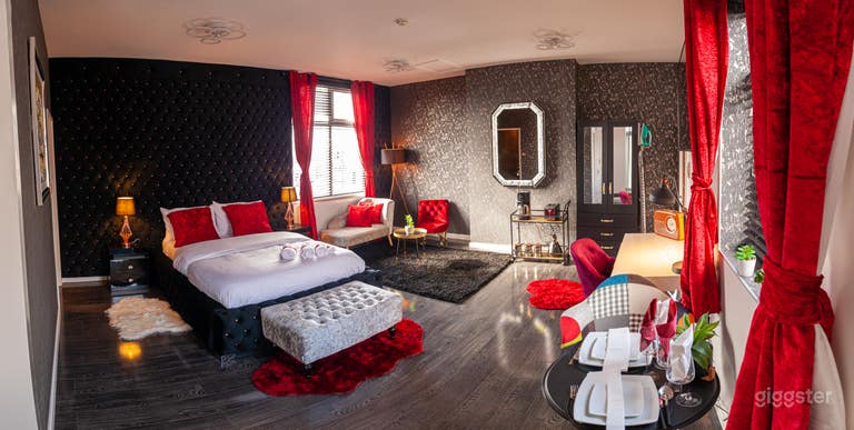  Luxurious penthouse suite with red , black and silver features  