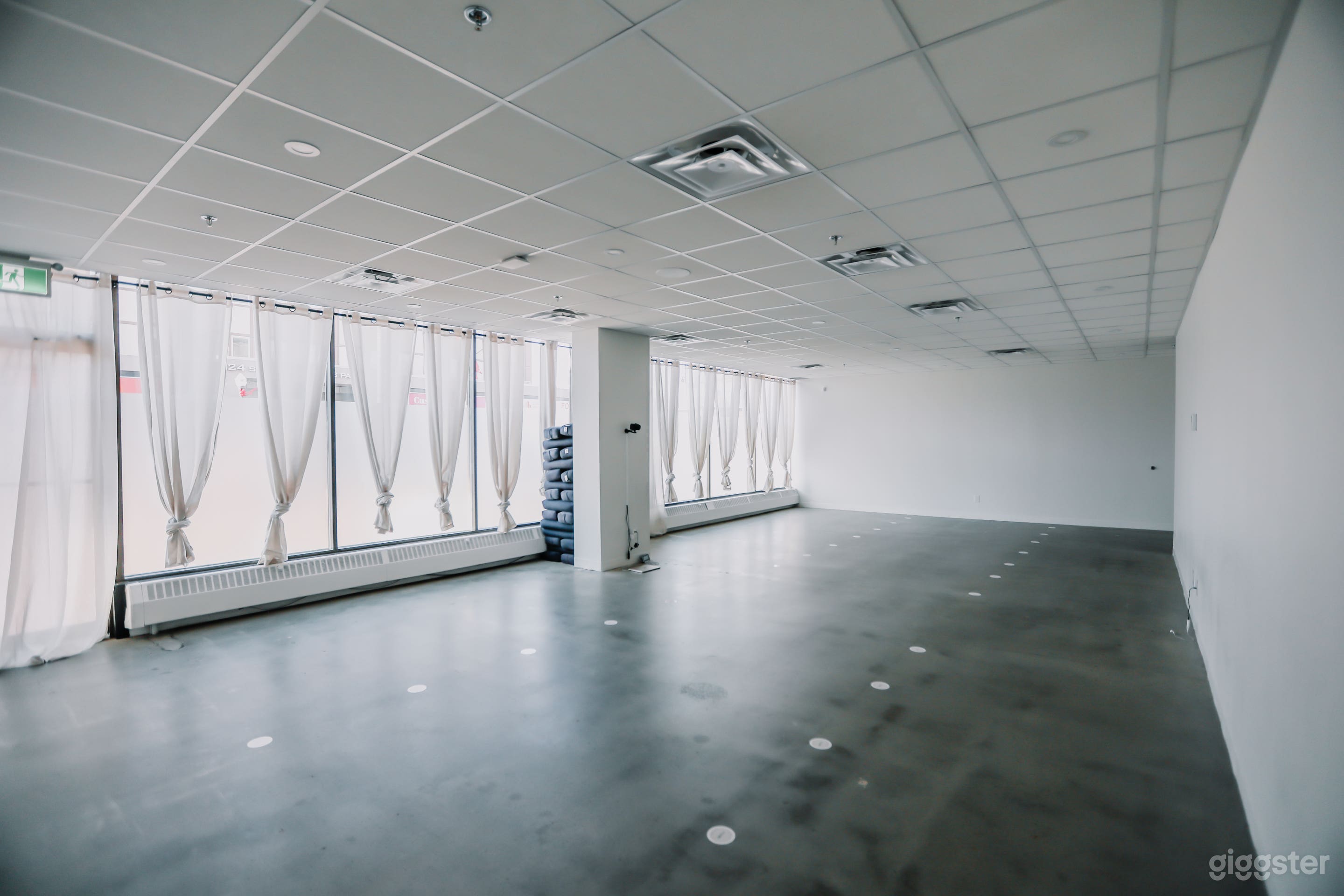 A clean, minimal studio with ample room for movement-based activities, training sessions, and creative productions.