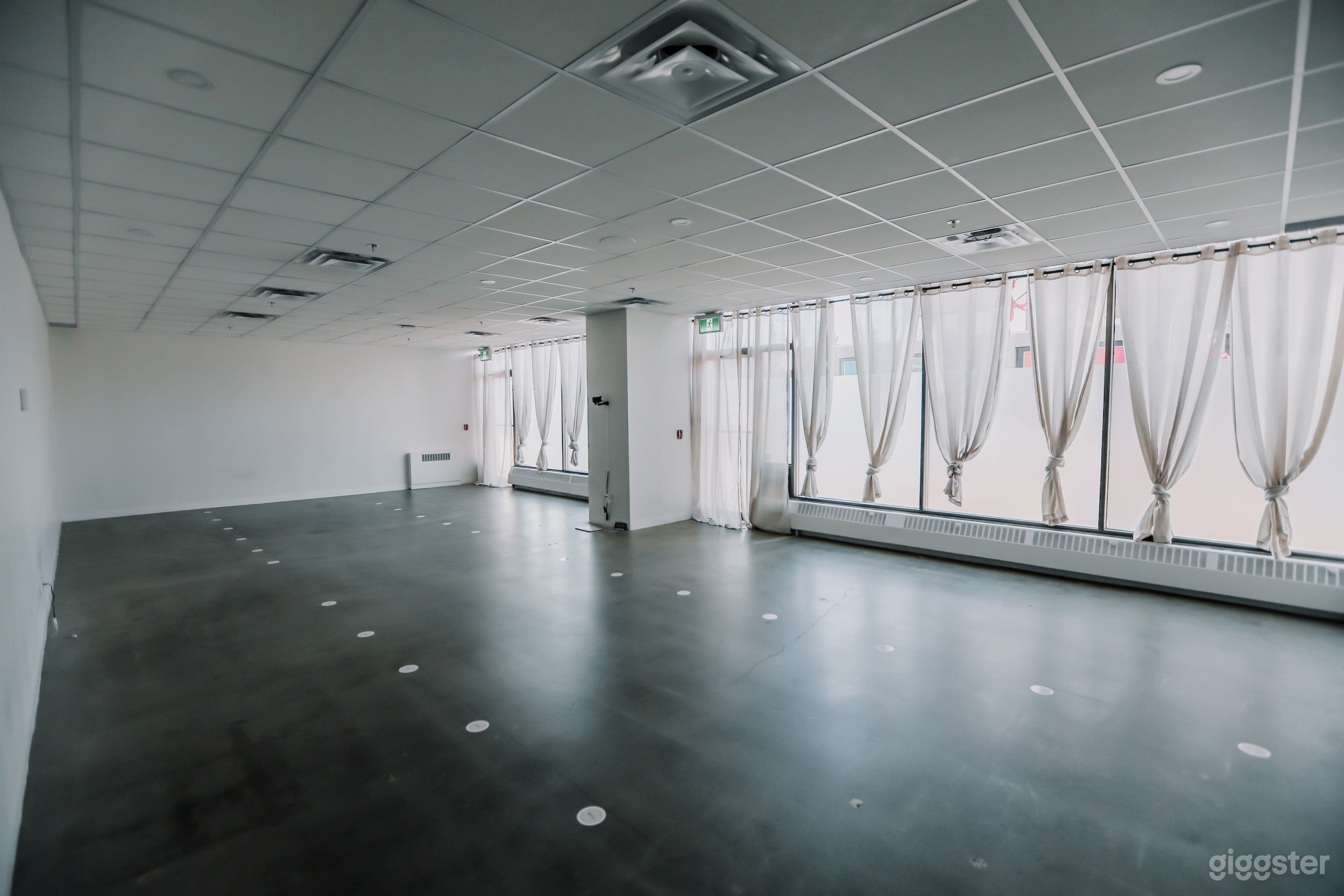 A modern, open-concept space with natural light and a serene atmosphere, perfect for events, workshops, and wellness gatherings.