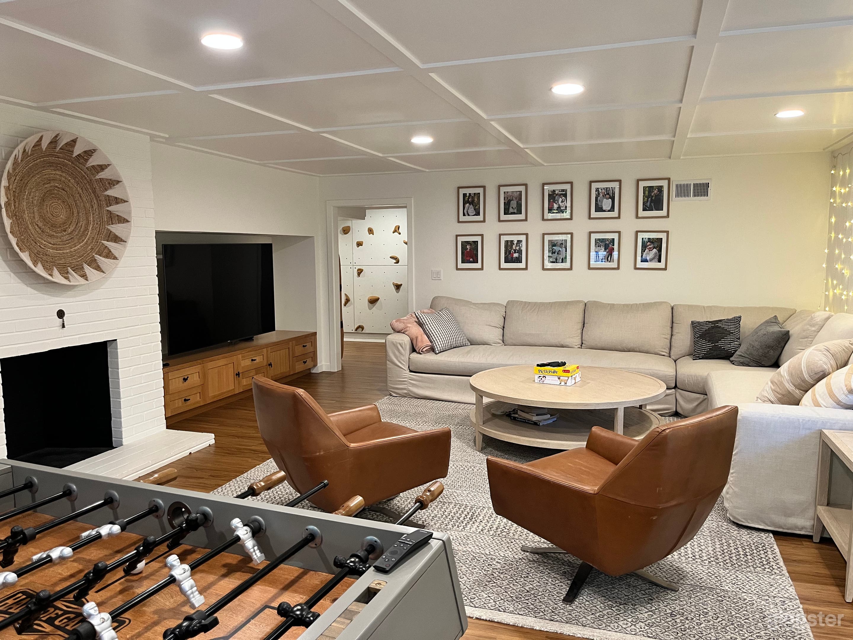 Basement also has fireplace, punching bag, foosball table, kitchenette, and couch of unusual size. 