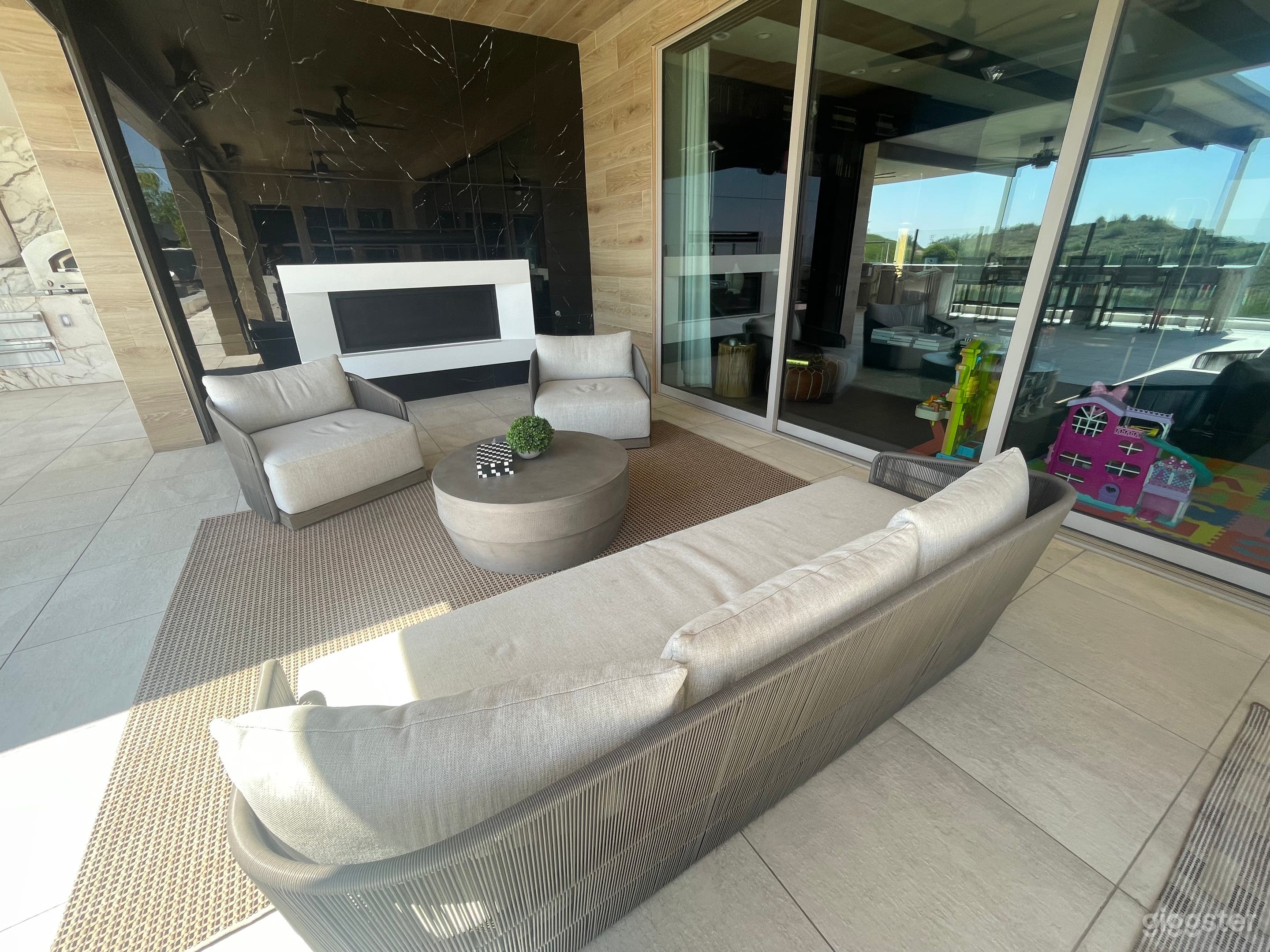 outdoor living room set in California great room with adjacent fire place 