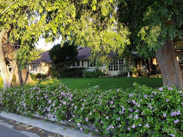  Front of house with large, long grass area, beautiful hardscaping and landscaping. 
