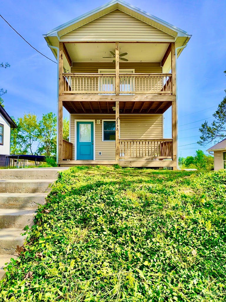 2-story house with wide front porch and balcony