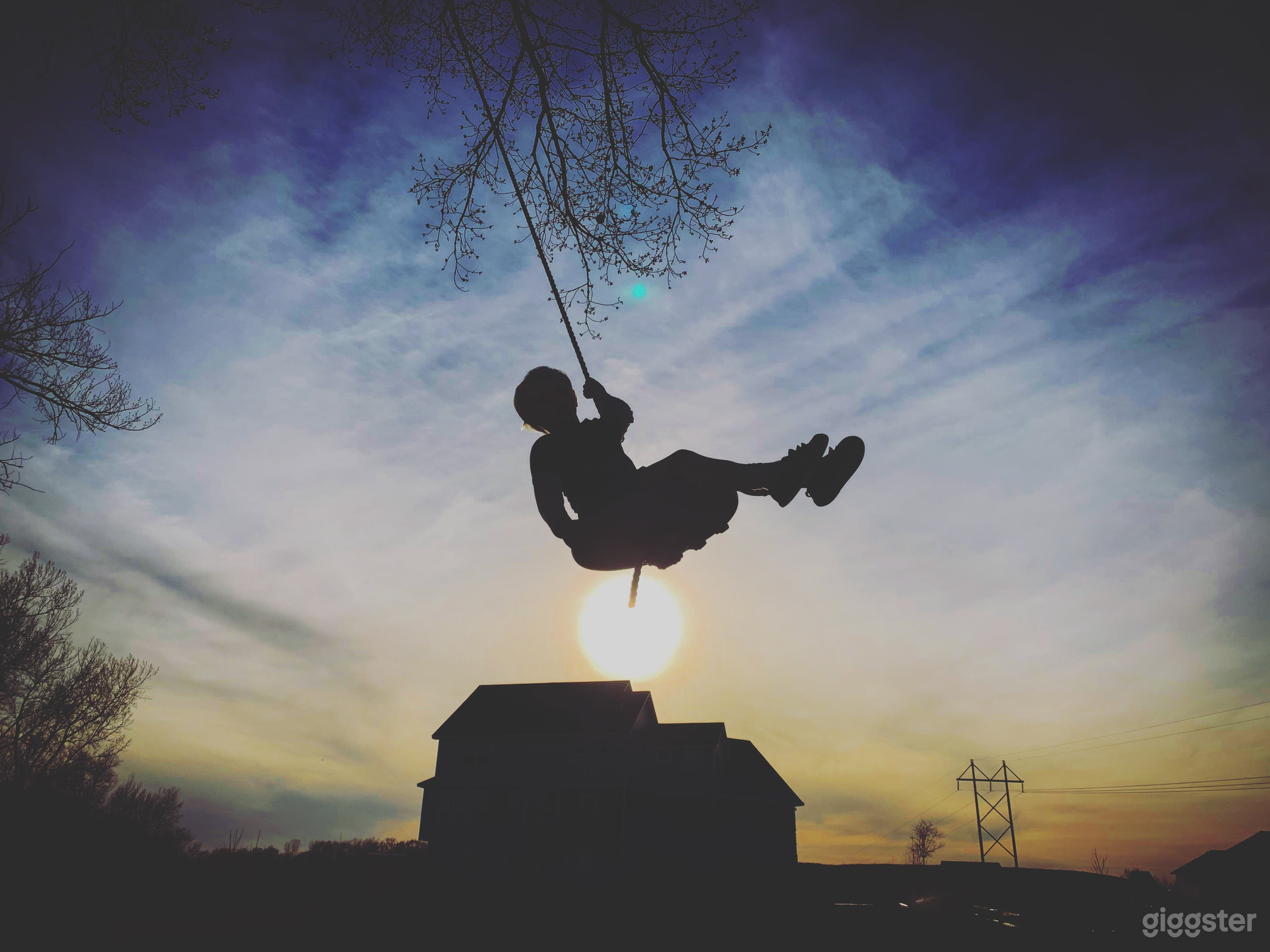 Back view at sunset. Tree swing. 