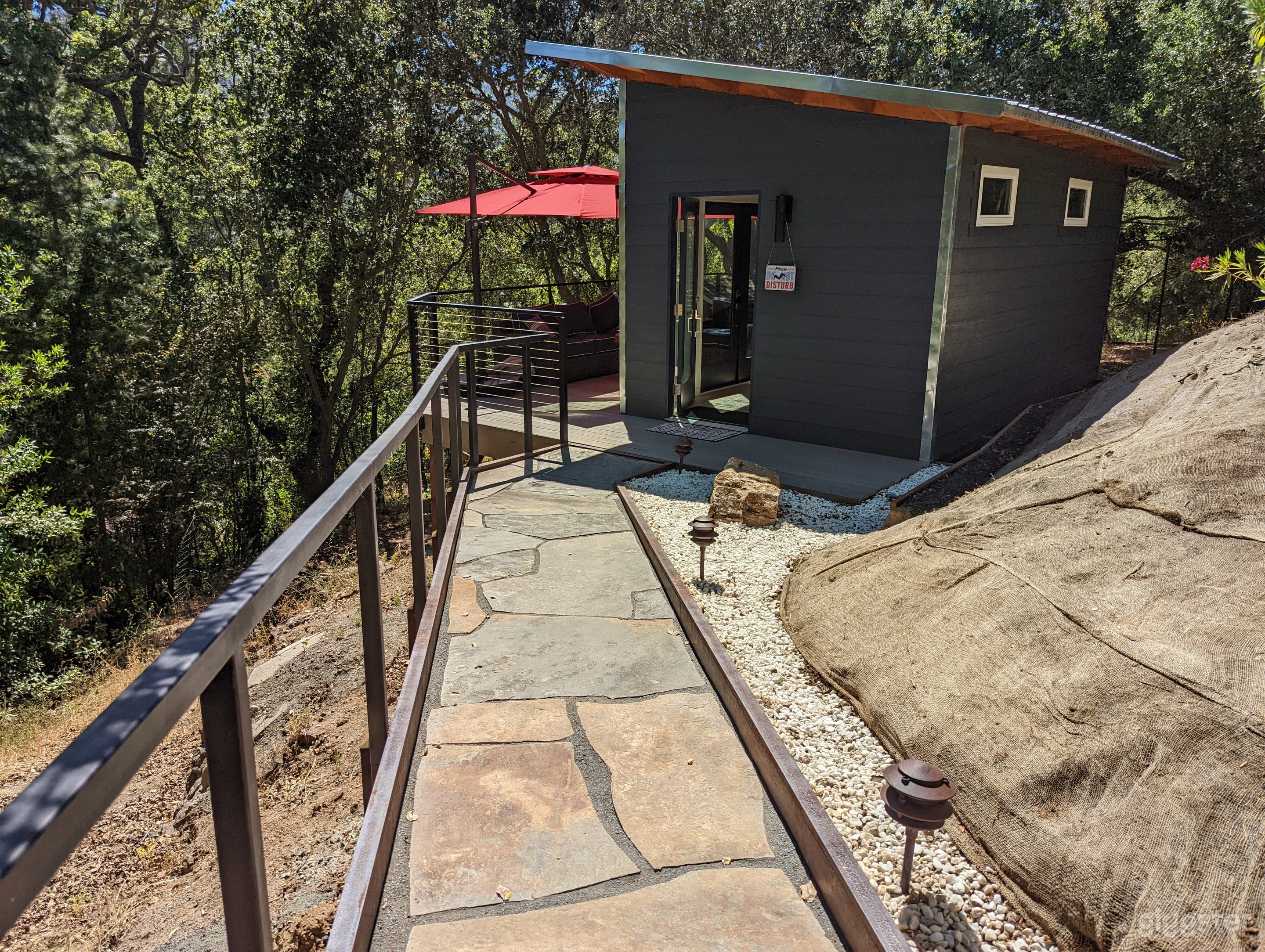 The stone walkway approach to lean-to office shed and deck