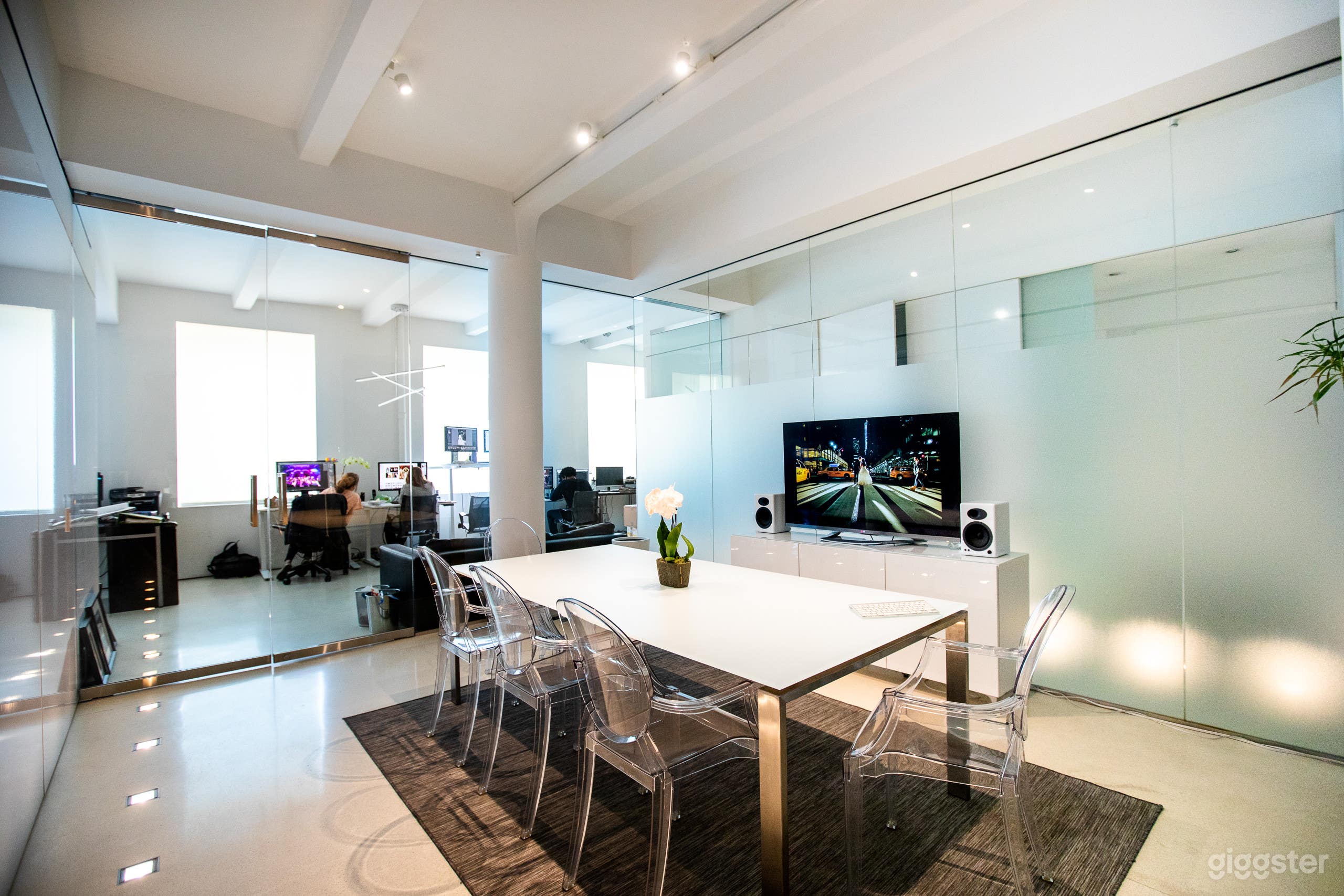 View of the all glass conference room.  Two sides have privacy frosting.  Glass and Stainless Steel table seats 8.