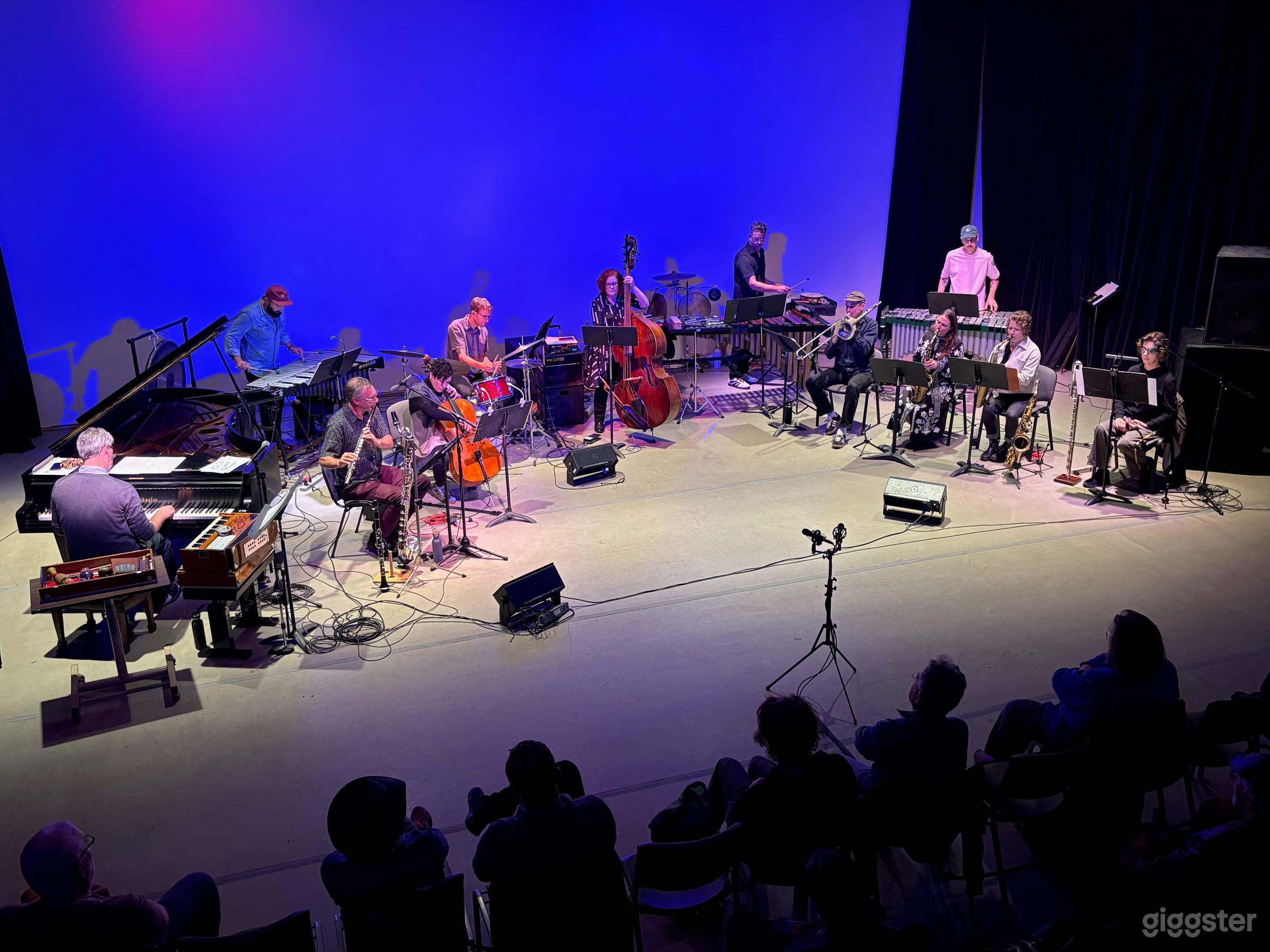 Live music performance with large ensemble including grand piano