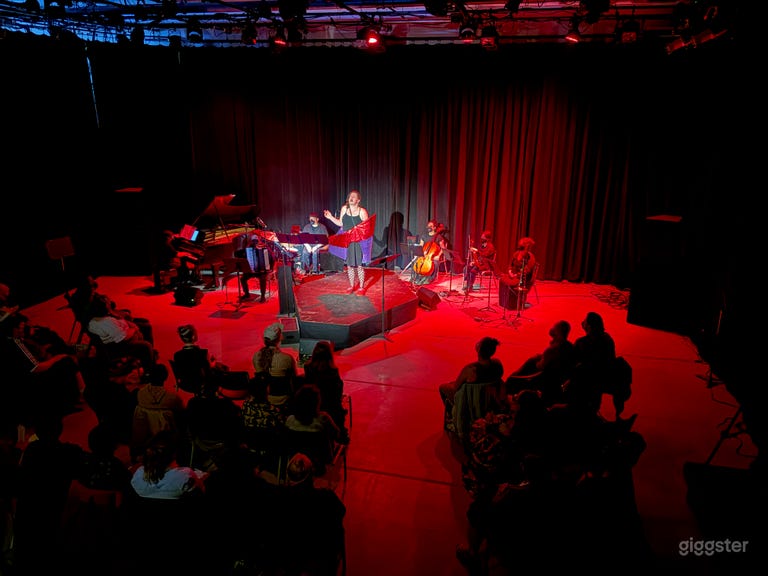  Music theater performance with rear black curtains close and platforming from the venue
 