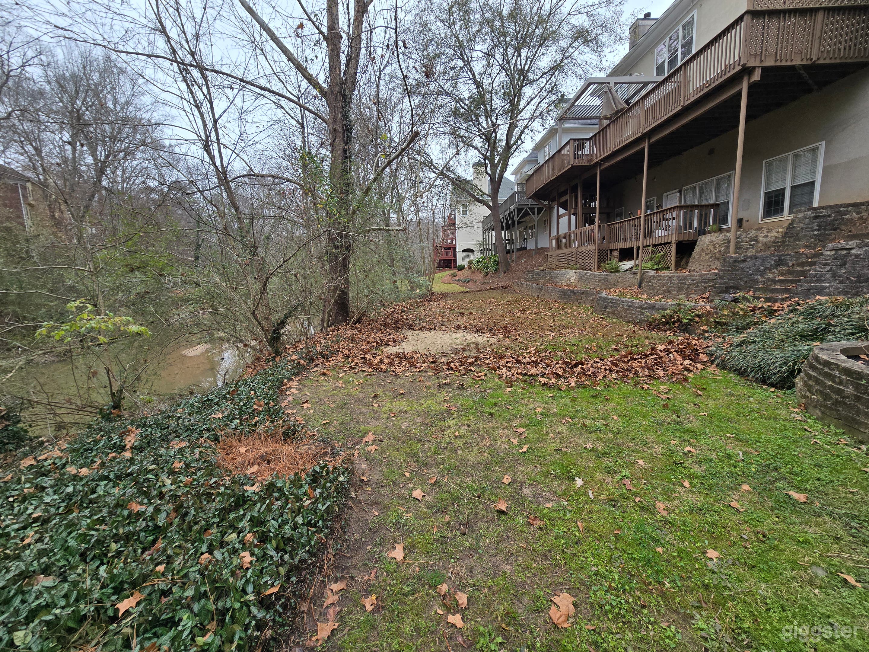 Spacious Sloped Wooded Backyard Photo 1
