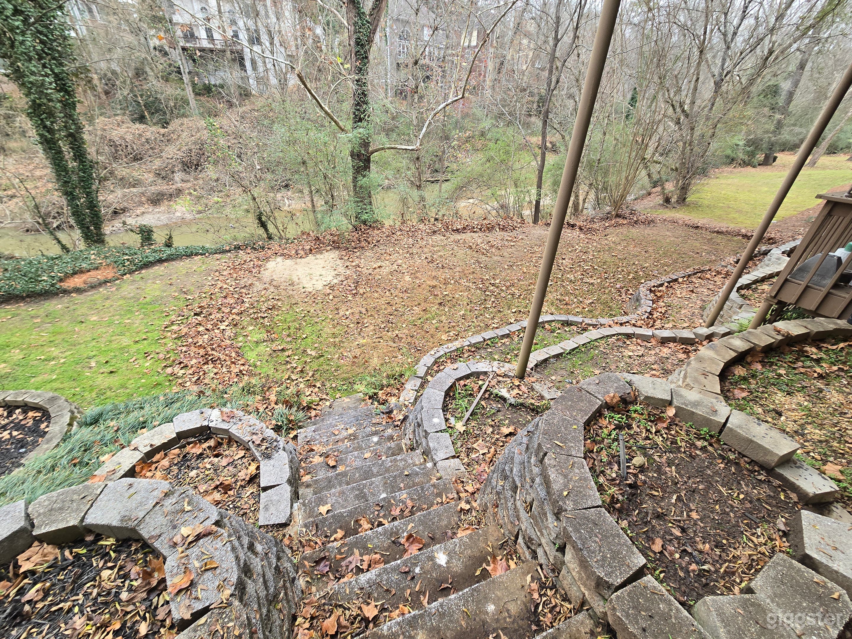 Spacious Sloped Wooded Backyard Photo 3