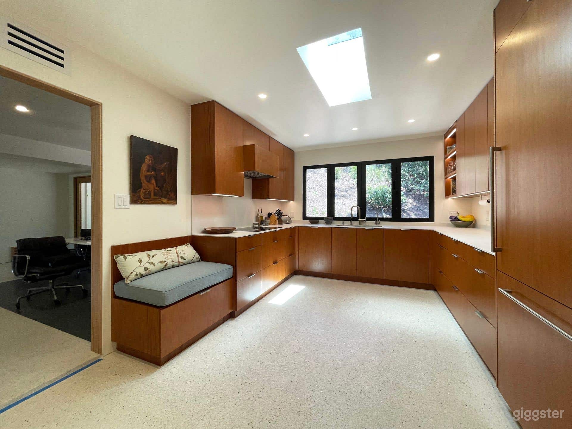 Kitchen with bifolds, bench, skylight, and under cabinet lighting
