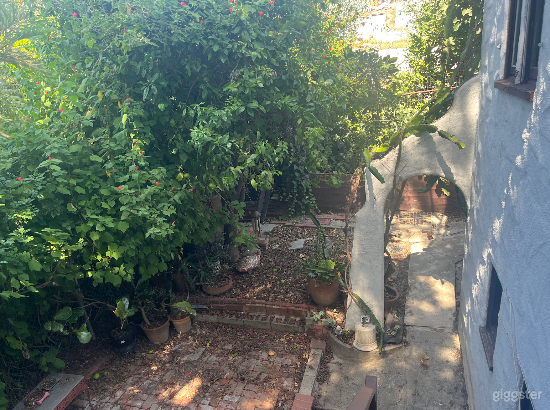 Beautiful Spanish Archway. Location adorned with native plants, wind chimes and statues/decorations.