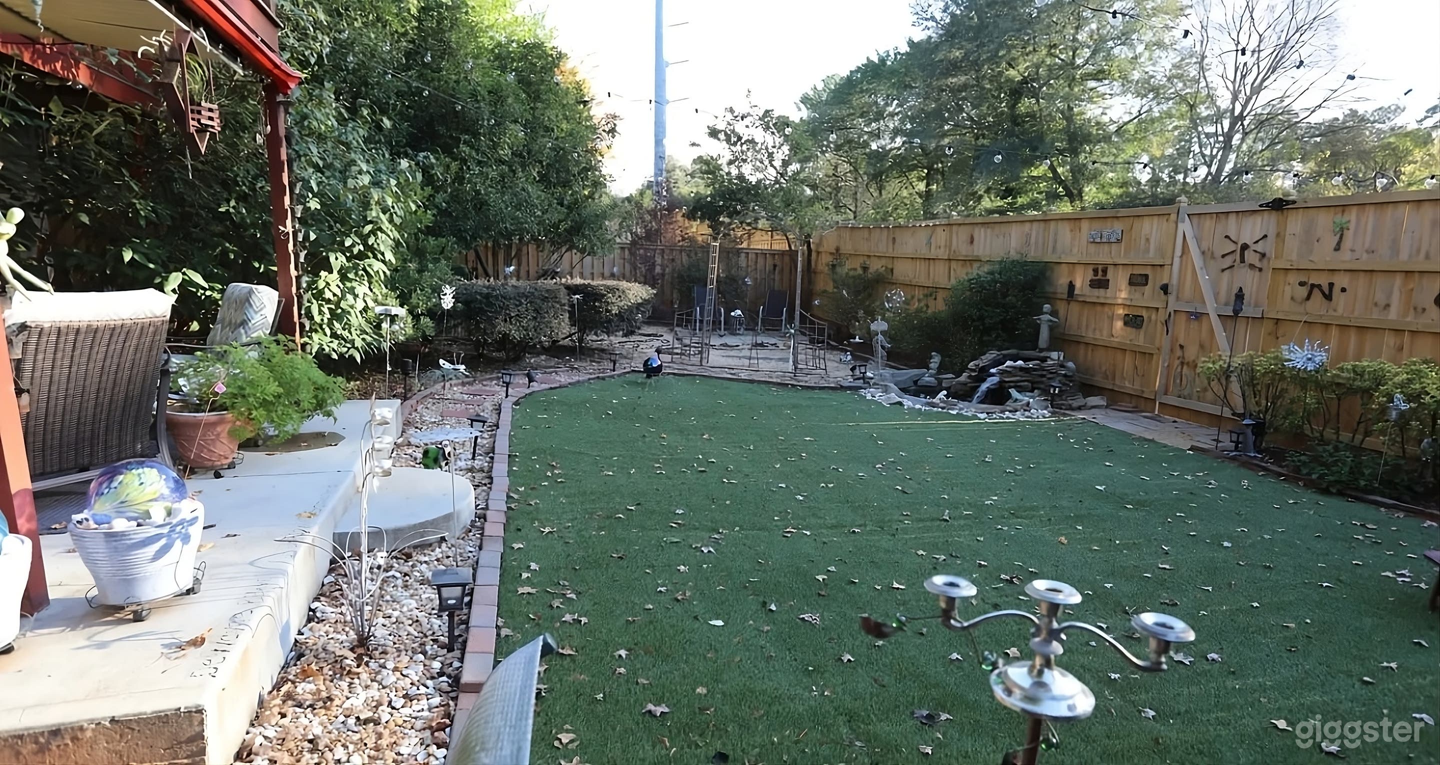 Lush Backyard with Covered Seating Photo 2