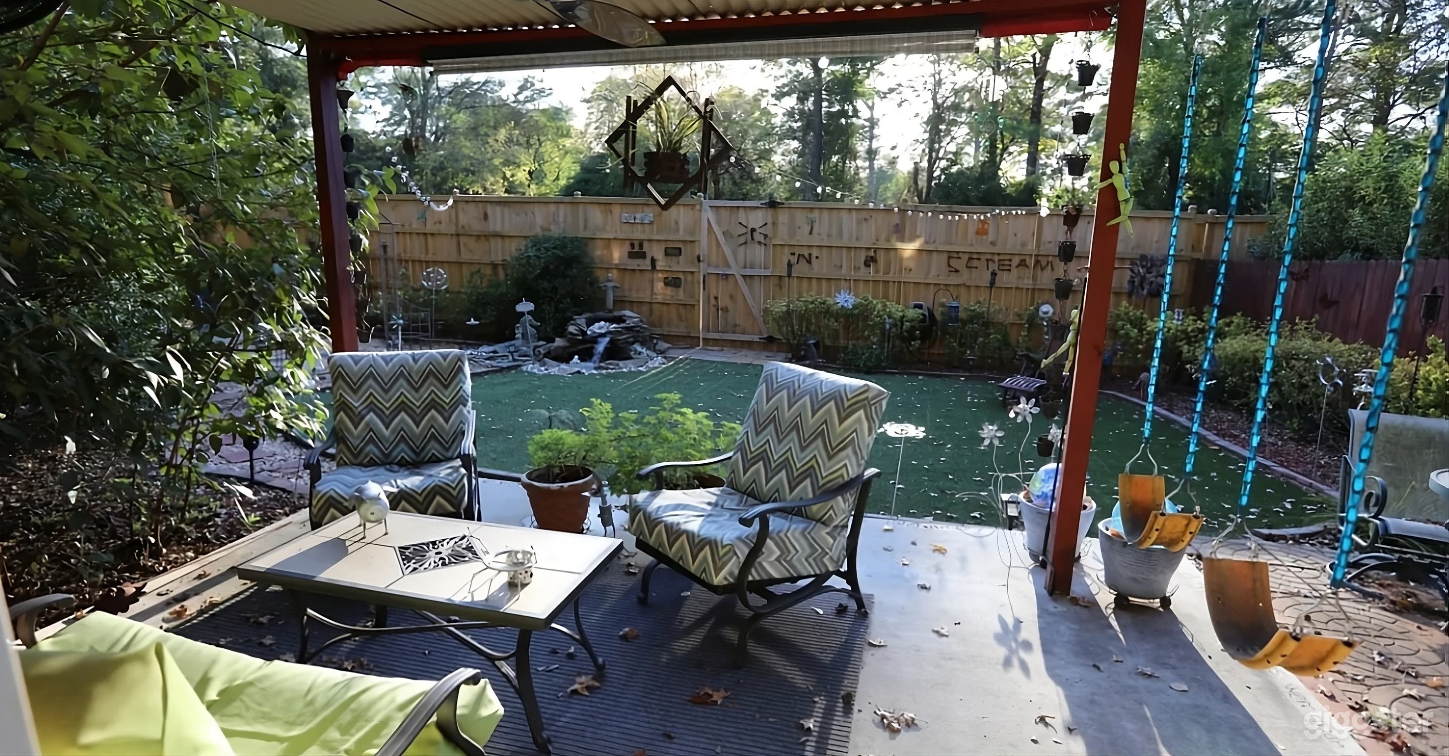 Lush Backyard with Covered Seating Photo 1