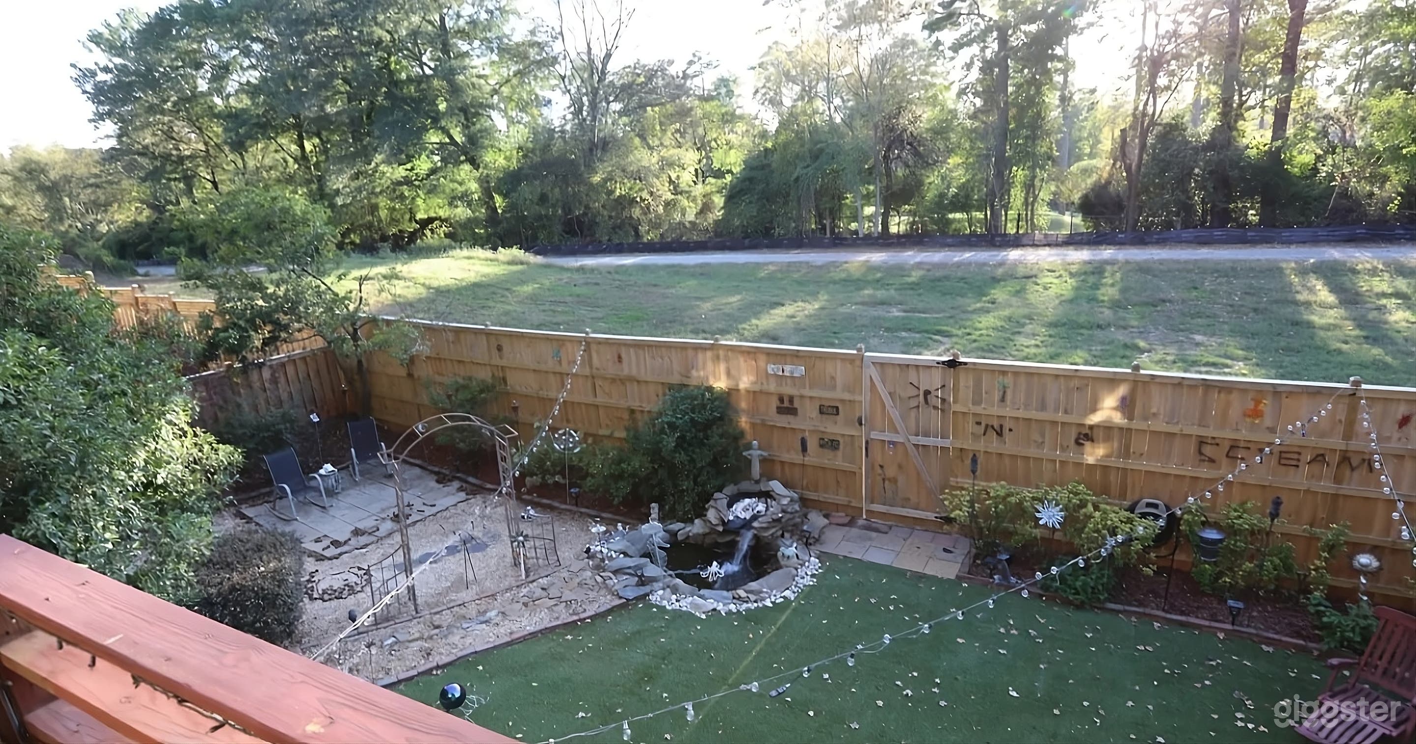 Lush Backyard with Covered Seating Photo 4